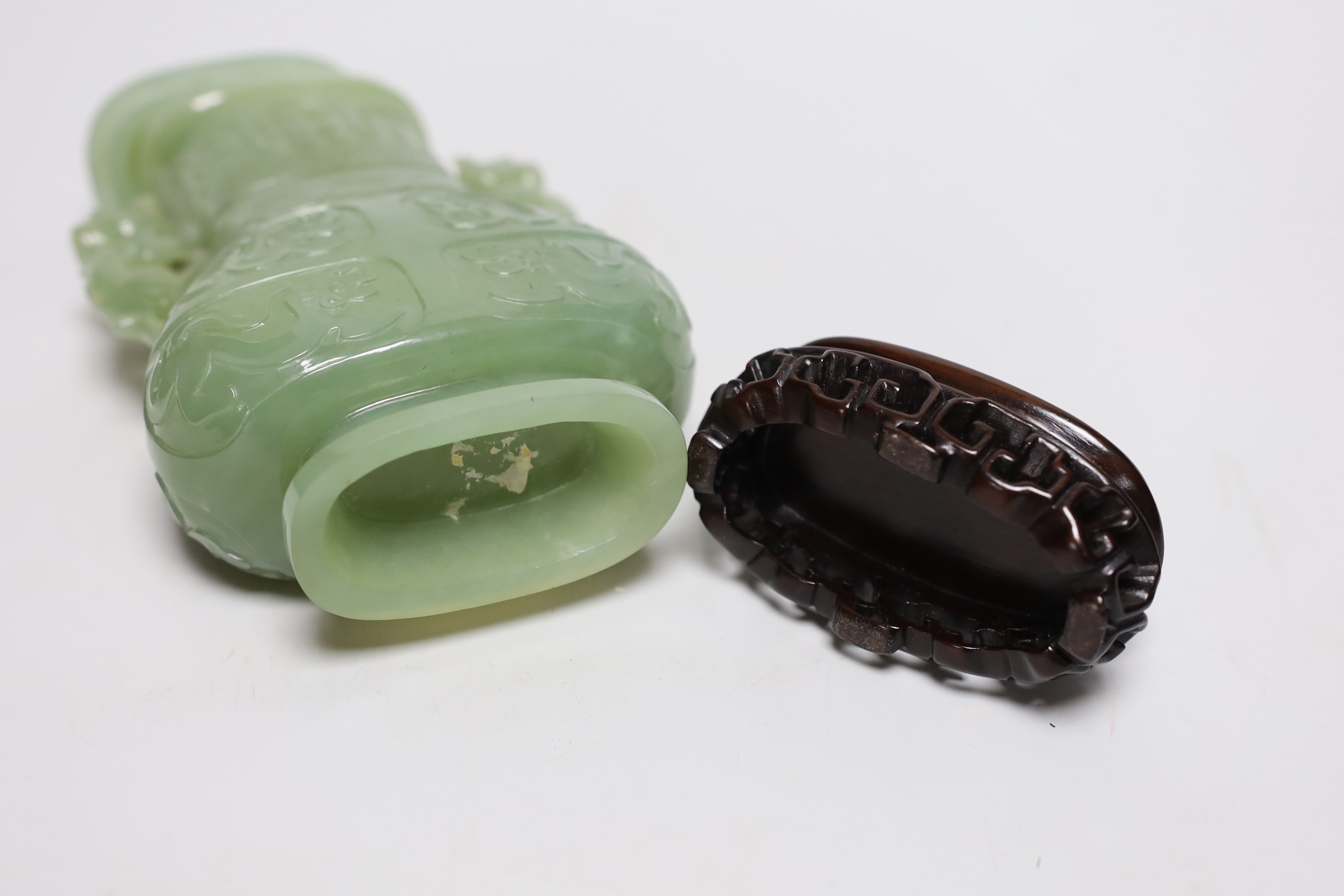 A Chinese carved bowenite jade vase and cover on hardwood stand, 23cm, with fitted case